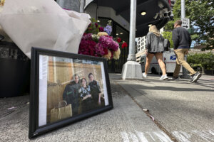 framed photo of Eina Kwon and Sung Kwon at a sidewalk memorial.