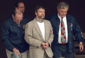 Ted Kaczynski is flanked by federal agents