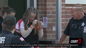 Lori Vallow Daybell is seen smiling and in handcuffs as she leaves court.