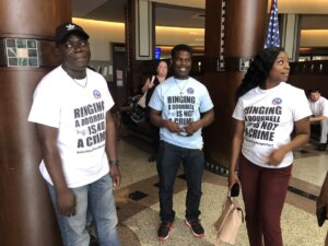 Three members of Ralph Yarl's family wear matching t-shirts that say, 'Ringing a doorbell is not a crime'