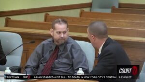 William Zelenski sits in court with his attorney