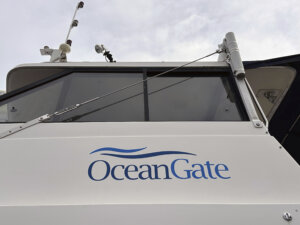 logo for OceanGate Expeditions is seen on a boat parked near the offices of the company