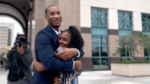 Travis Rudolph hugs a woman outside of the courthouse.