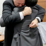 Former Marjory Stoneman Douglas High School School Resource Officer Scot Peterson hugs his attorney.