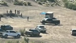 Authorities search the scene where a body was found in a bonfire pile at Tonto National Forest