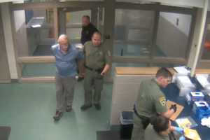 Donald Santini is booked into the Orient Road Jail