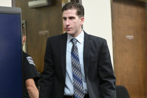 Bryan Kohberger, in a suit, enters the courtroom.