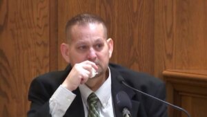 William Zelenski holds a tissue as he becomes emotional on the stand.