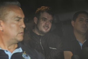 Joran van der Sloot is driven away from prison in a police vehicle.