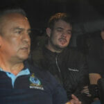 Joran van der Sloot is driven away from prison in a police vehicle.