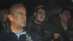 Joran van der Sloot is driven away from prison in a police vehicle.