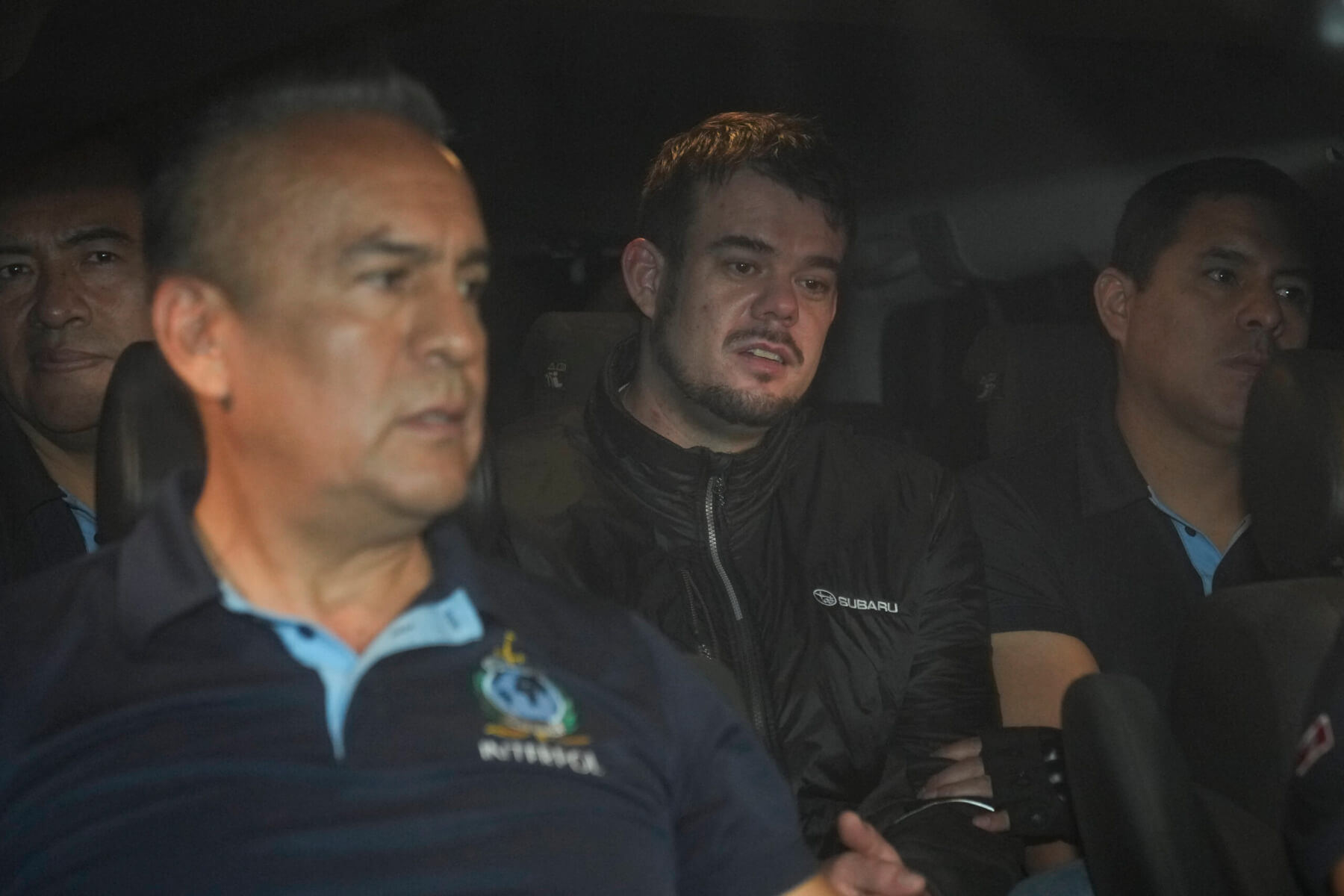 Joran van der Sloot is driven away from prison in a police vehicle.