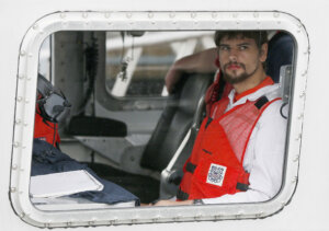 Nathan Carman arrives in a small boat at the U.S. Coast Guard station
