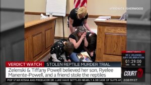 Photo shows people praying in a courtroom