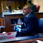 Oakland County Sheriff Lt. Tim Willis holds the gun Ethan Crumbley used to kill four students and injured six others.