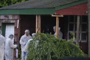 Crime laboratory officers arrive to the house where a suspect has been taken into custody on New York's Long Island