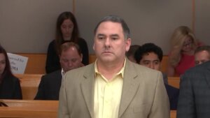 Man stands in court listening to verdict