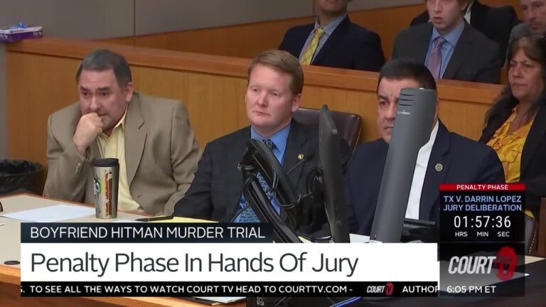 Three men sit at the counsel table in court