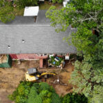 Aerial photo of excavator outside house