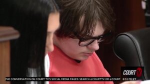 Ethan Crumbley looks down as he sits in court