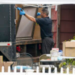 Authorities search the home of suspect Rex Heuermann.