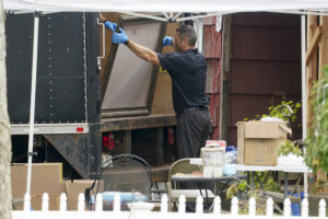 Authorities search the home of suspect Rex Heuermann.