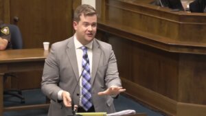 A man in a suit and tie gestures in court