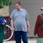 Asa Ellerup and Victoria Heuermann walk through a Best Buy parking lot