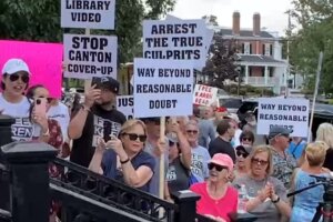 Protesters holding signs