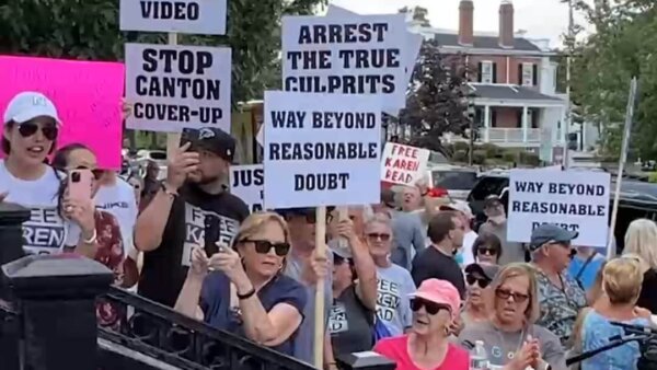 Protesters holding signs