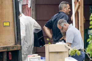 Authorities search the home of suspect Rex Heuermann.