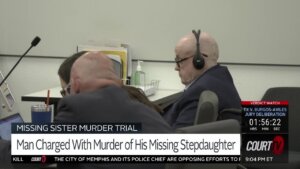 Michael Turney sits with headphones on in court