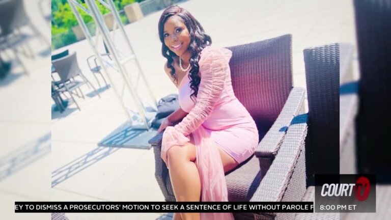 Photo of woman sitting with legs crossed in a pink dress