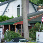 Crime laboratory officers arrive to the house where a suspect has been taken into custody on New York's Long Island