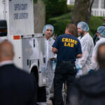 Crime laboratory officers arrive to the house where a suspect has been taken into custody on New York's Long Island