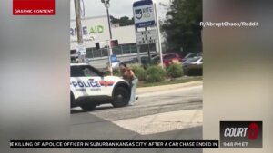 Gun-wielding woman hit by cop car.