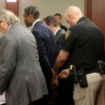 A deputy places handcuffs on Henry Ruggs III in court.