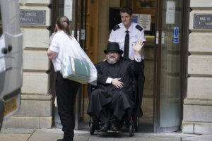 Nicholas Rossi from he U.S. waves as he leaves the Edinburgh Sheriff and Justice of the Peace Court