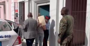 Woman leaves building holding papers up to face