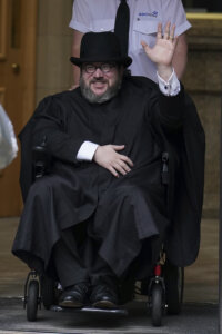 Nicholas Rossi from he U.S. waves as he leaves the Edinburgh Sheriff and Justice of the Peace Court
