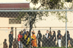 Nine members of Congress and others wait to enter Marjory Stoneman Douglas High School