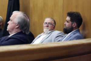 Co-defendants Gregory Case second from right, and his son Brandon Case appear in court