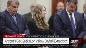 a woman stands between two men in suits in court