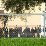 Nine members of Congress and others wait to enter Marjory Stoneman Douglas High School