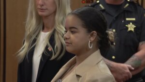 A young woman speaks at a podium