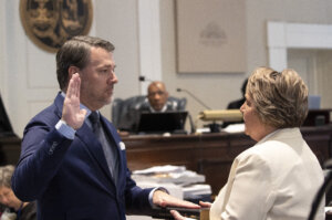 Michael Gunn, principle at Forge Consulting, gives the witness oath by Colleton County Clerk of Court Rebecca Hill, right, during Alex Murdaugh's double murder trial