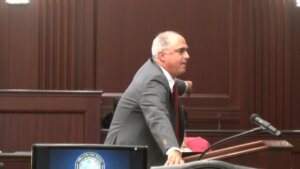 a man in a suit speaks in court