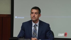 A man in a suit testifies in court