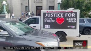 A truck with a sign that says Justice John O'Keefe Karen Read with a heart