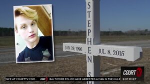 Stephen Smith pic next to a cross grave marker.